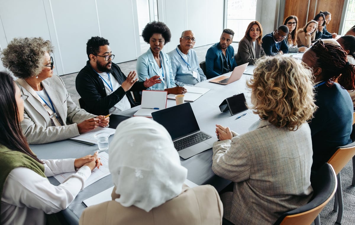 Multiethnic group of businesspeople engaged in a strategy and brainstorming session around a conference table.